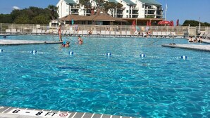 A clear blue pool with a '6-8 FT' depth marker, surrounded by a tiled deck.