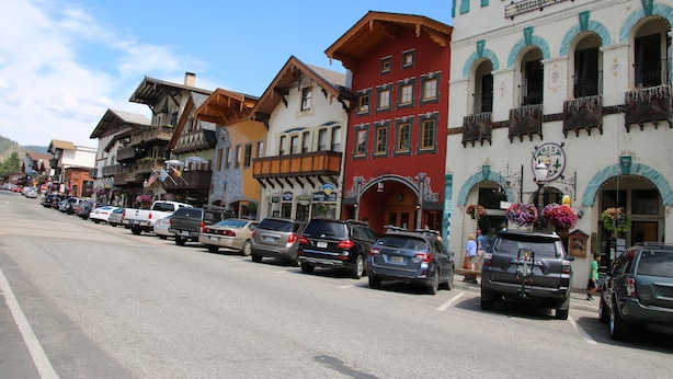 A row of colorful buildings with a pharmacy on the right.