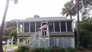 A two-story building with a covered porch, a flag, and a 'No Parking' sign. - Beach/Pier/Restaurants/Shopping/Outstanding Location...100yards to All! Parking  (Folly Beach)