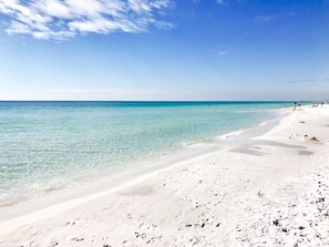 A beach with clear turquoise water and white sand.