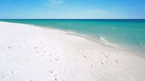 A beach with white sand and clear turquoise water. - WALK STEPS TO BEACH AND POOL.  GREAT LOCATION!  close to activities and shopping (Destin)