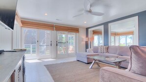 A modern living room with a sofa, coffee table, and a television. - Spectacular 1 Bedroom, Oceanfront Villa! BRAND NEW RENOVATION!! (Kiawah Island)