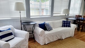 A living room with two white sofas, a round coffee table, and a patterned rug. - July 4-11 & Jul 11-18 last-minute availability! (Rehoboth Beach)