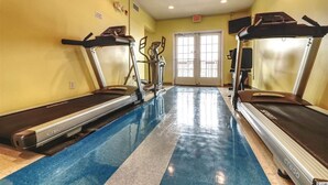 A gym with treadmills and an elliptical machine, a door leading outside, and a tiled floor. - Pristine Condo at Beachwalk Villas in North Myrtle Beach, SC Cherry Grove.  (North Myrtle Beach)