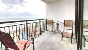 A balcony with a view of the beach, two chairs, and a small table. - Pristine Condo at Beachwalk Villas in North Myrtle Beach, SC Cherry Grove.  (North Myrtle Beach)