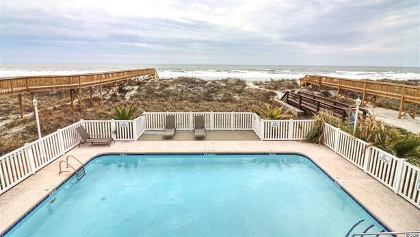 A pool with a view of the beach and ocean. - Pristine Condo at Beachwalk Villas in North Myrtle Beach, SC Cherry Grove.  (North Myrtle Beach)