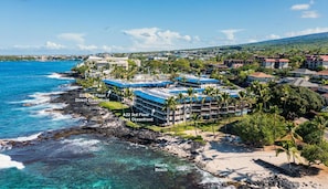A coastal hotel with multiple floors, direct oceanfront access, and a beach nearby.