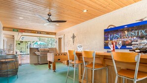 A bar area with wooden bar stools, a grill, and a ceiling fan. - PRIVATE HEATED SWIMMING POOL & HOT TUB Amazing Views, Privacy & Close to SEDONA! (Cottonwood)