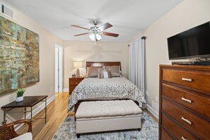 A bedroom with a bed, a ceiling fan, a TV, a dresser, and a painting on the wall. - AMAZING VIEWS FROM THIS 2 BEDROOM 2 BATH BEACHSIDE CONDO  (Gulf Shores)