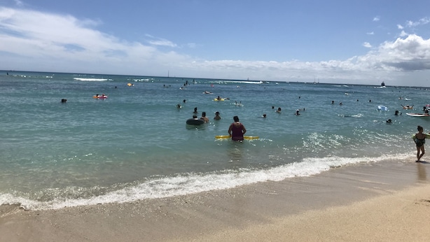 A beach with people swimming and surfing, boats in the distance, and a clear sky. - BOOK 30 DAYS OCT 15-NOV FREE PARKING! UNIT 52 WALK TO INTL MKT, TARGET, BEACH (Honolulu)