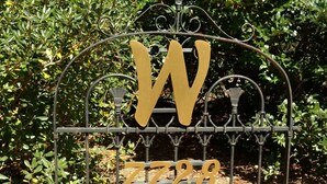 A metal gate with a large 'W' and the number '7728' on it.