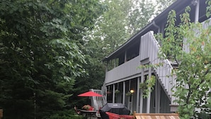 A backyard with a wooden pergola, a barbecue grill, and a dining area with outdoor furniture. - Bayfield- Charming Condo, Jumping Off Point to Apostles (Bayfield)