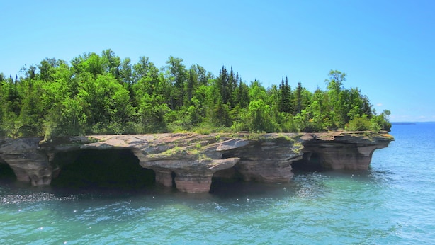 A natural rock formation with a forested area above it, surrounded by water. - Bayfield- Charming Condo, Jumping Off Point to Apostles (Bayfield)