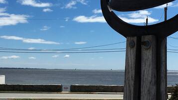 A large bell structure with a view of the ocean and a clear sky.