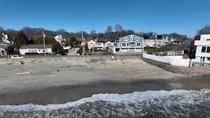 A beach with houses in the background. - Charming Carriage House - Beach - Ocean Views - Fireplace (New London)