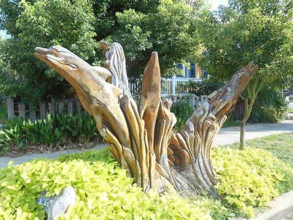 Stunning sculpture garden with an abstract, organic form surrounded by lush greenery and a serene atmosphere.