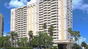 A multi-story hotel with a symmetrical facade, featuring balconies on each floor.