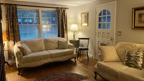 A living room with two sofas, a chair, a lamp, and a door. - Guest Cottage on Country Estate (Watertown)