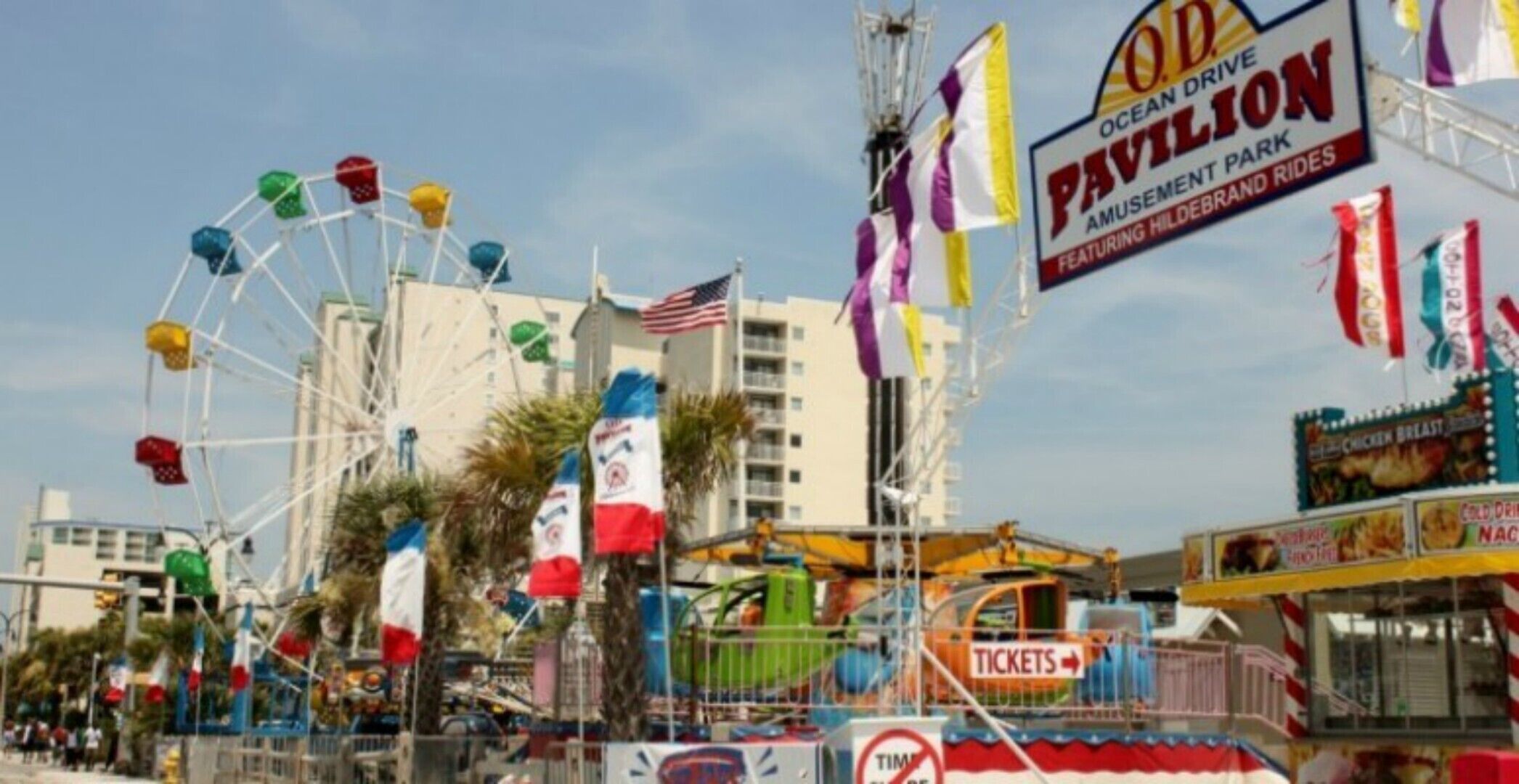 A Ferris wheel, a sign for Ocean Drive Pavilion, and a ticket booth.