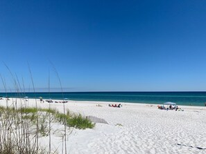 A beach with white sand, clear blue sky, and calm sea. - Book Fall specials now! Family Friendly, Close To The Beach! No Hurricane damage (Pensacola Beach)