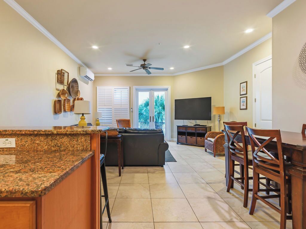 A spacious living area with a kitchen, dining area, and a TV.