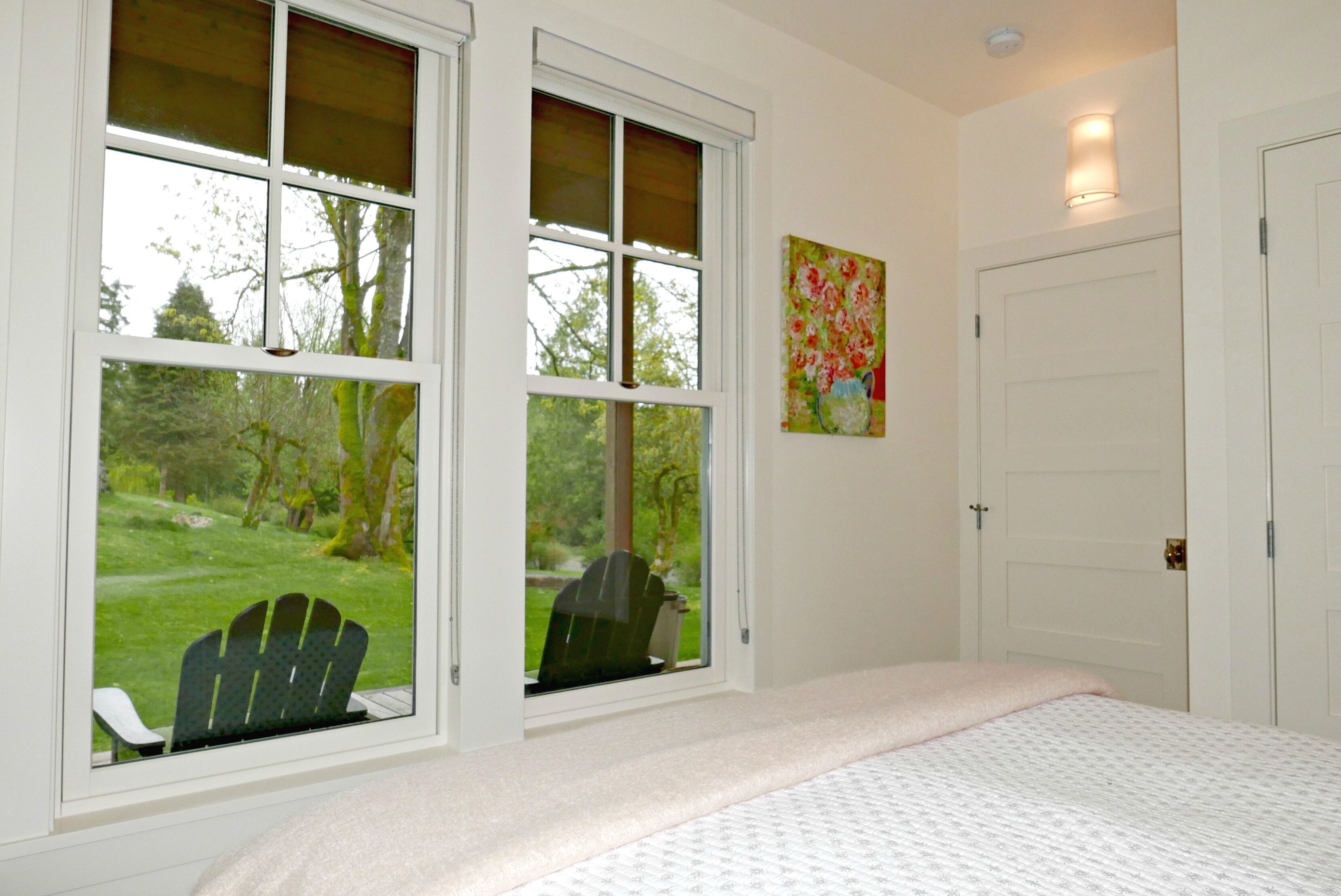 Bedroom on main floor overlooks porch and large lawn. Lots of natural light!