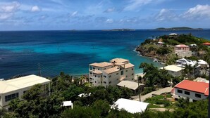 A coastal view with buildings, clear blue waters, and a distant island. - MANGO MOJO Penthouse Paradise! Stunning Views, Pool, Walk to Cruz Bay, Generator (St John)