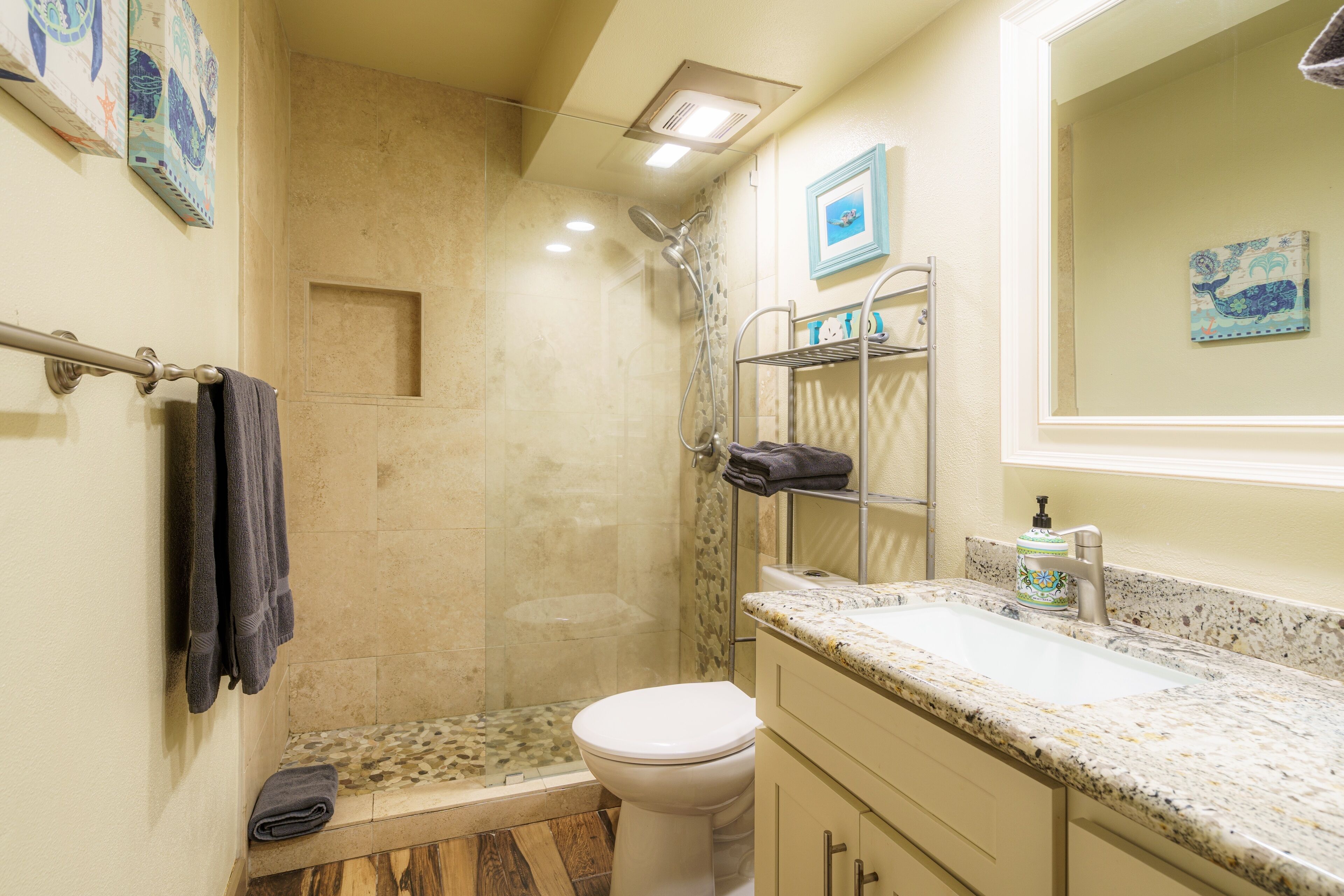 A bathroom with a shower, toilet, and sink.