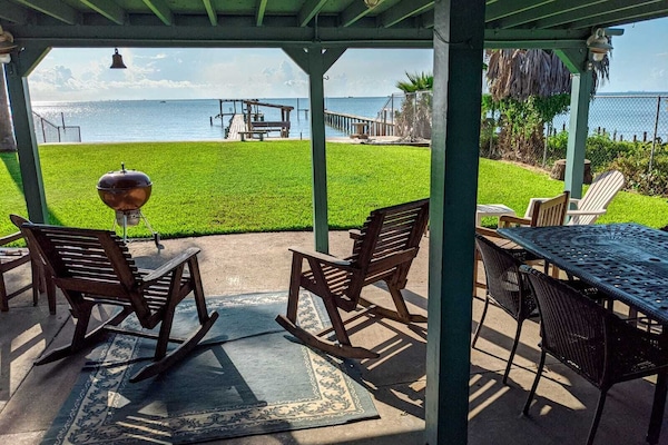 Covered patio with waterfront view. Sit down and enjoy the breeze.