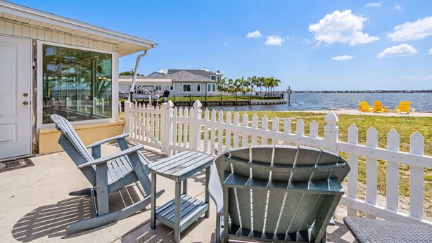 A coastal property with a deck, outdoor seating, and a view of the ocean. - Open Water Home with lots of dolphin and manatee sightings. Boat docking. (Ellenton)