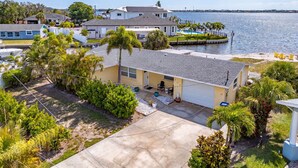 A residential area with houses, a dock, and a body of water. - Open Water Home with lots of dolphin and manatee sightings. Boat docking. (Ellenton)