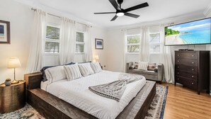 A bedroom with a bed, a TV, a dresser, and a ceiling fan. - Open Water Home with lots of dolphin and manatee sightings. Boat docking. (Ellenton)