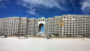 A large hotel with multiple balconies and a central archway.