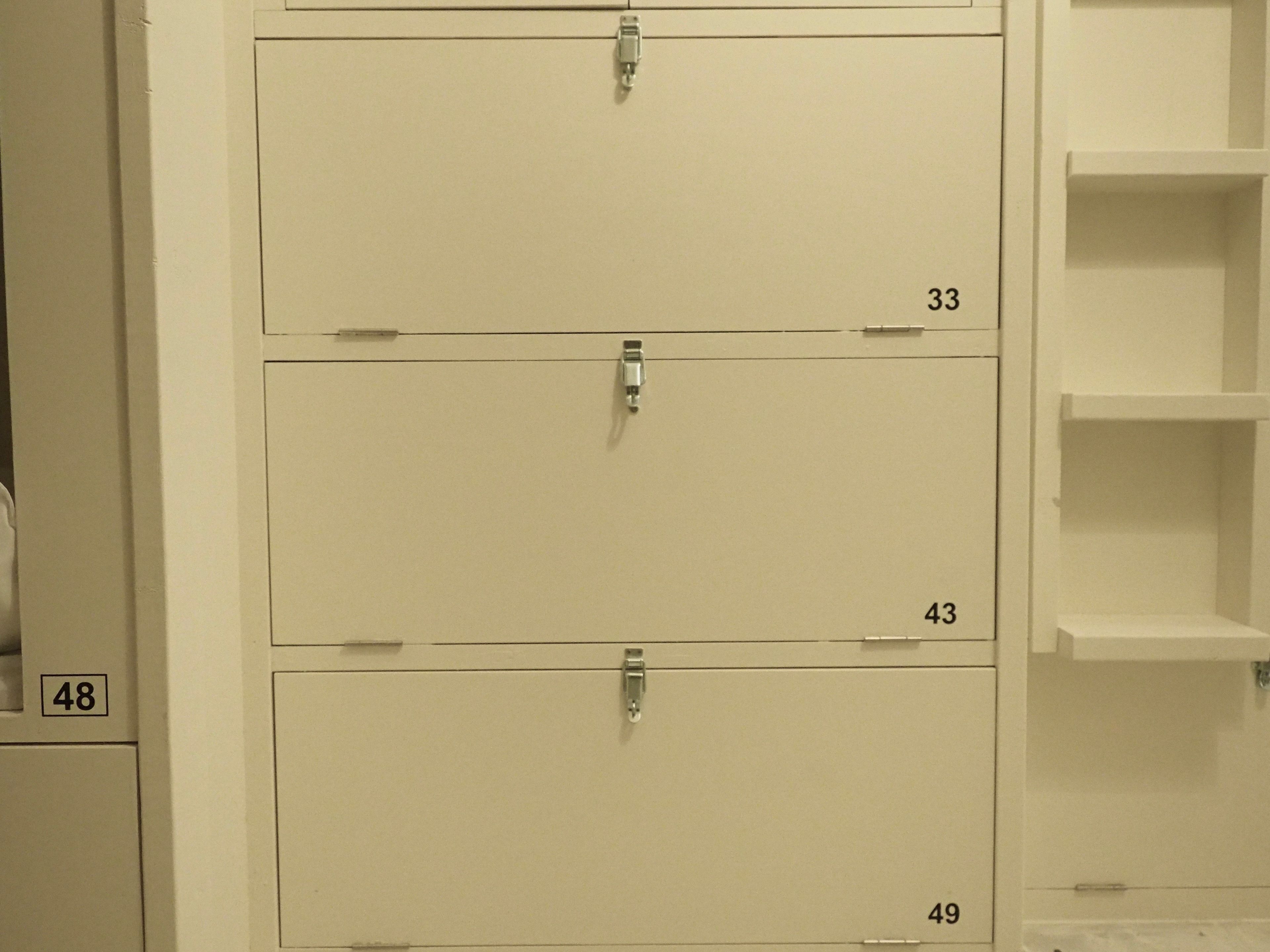 A set of white lockers with numbers 33, 43, and 49.