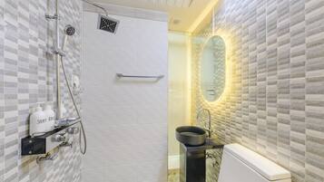 A bathroom with a shower, sink, and toilet.