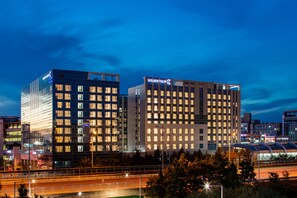 A modern hotel with a prominent "GOLDEN TULIP" sign, featuring a glass facade and multiple floors. - Golden Tulip Incheon Airport Hotel & Suites (Incheon)