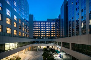 A modern building with multiple floors, large windows, and a central courtyard. - Golden Tulip Incheon Airport Hotel & Suites (Incheon)