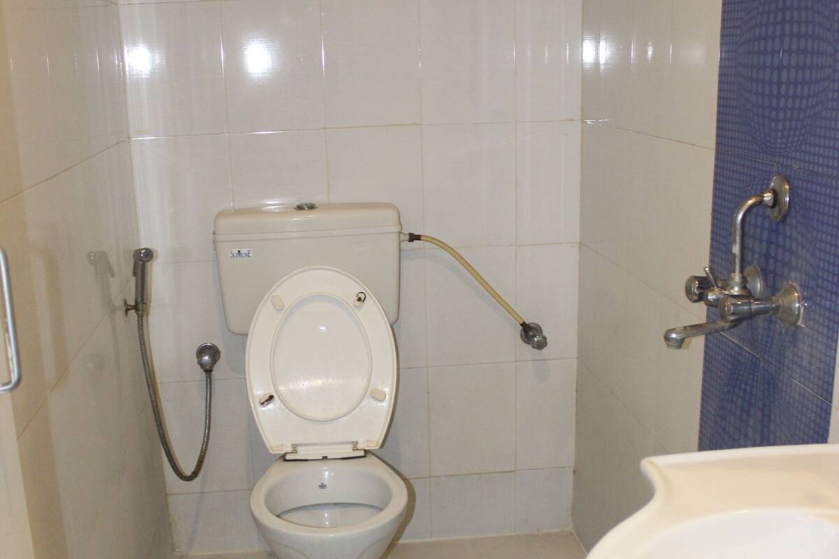 A small bathroom with a toilet, bidet, and sink.