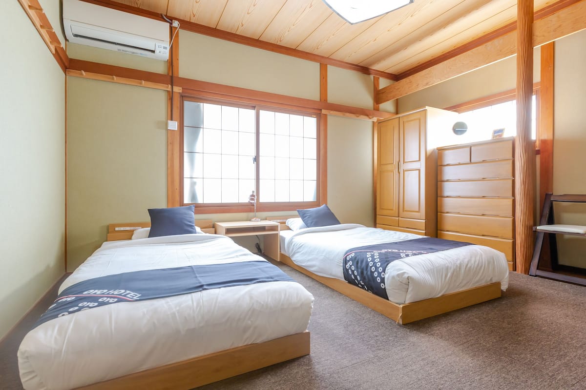western room with shared washroom - twin (non-smoking) | in-room safe, iron/ironing board, free wifi, bed sheets
