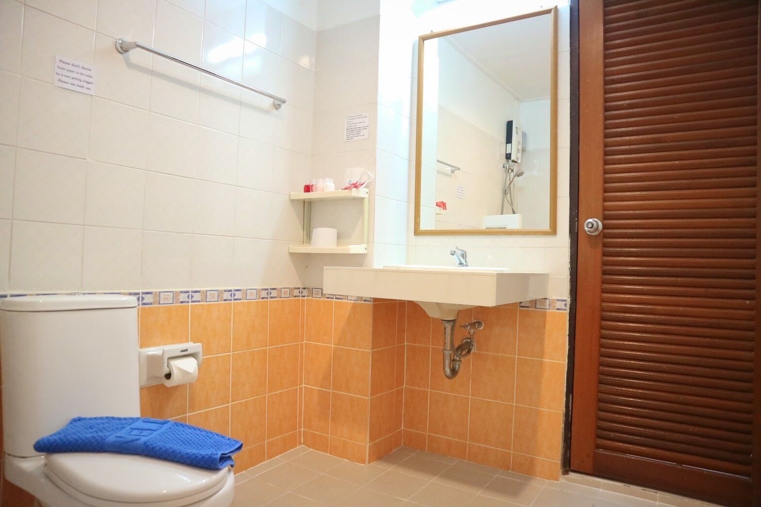 A bathroom with a toilet, sink, and shower.