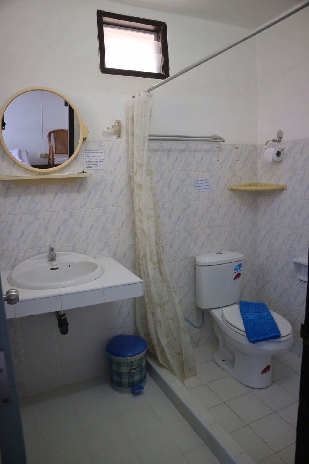 A bathroom with a sink, toilet, and shower curtain.