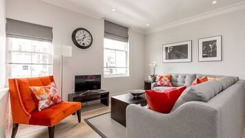 Apartamento, 1 quarto | Área de estar | TV de tela plana