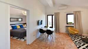 A modern apartment with a bedroom, dining area, and balcony. - Mediterraneo Garden Apartments (Zadar)