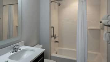 A modern bathroom with a white sink, toilet, and bathtub.