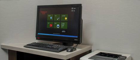 A desktop computer with a monitor, keyboard, mouse, and an HP LaserJet Pro M402n printer on a desk.