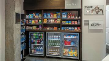 A snack and beverage vending area with various brands of chips, snacks, and drinks.