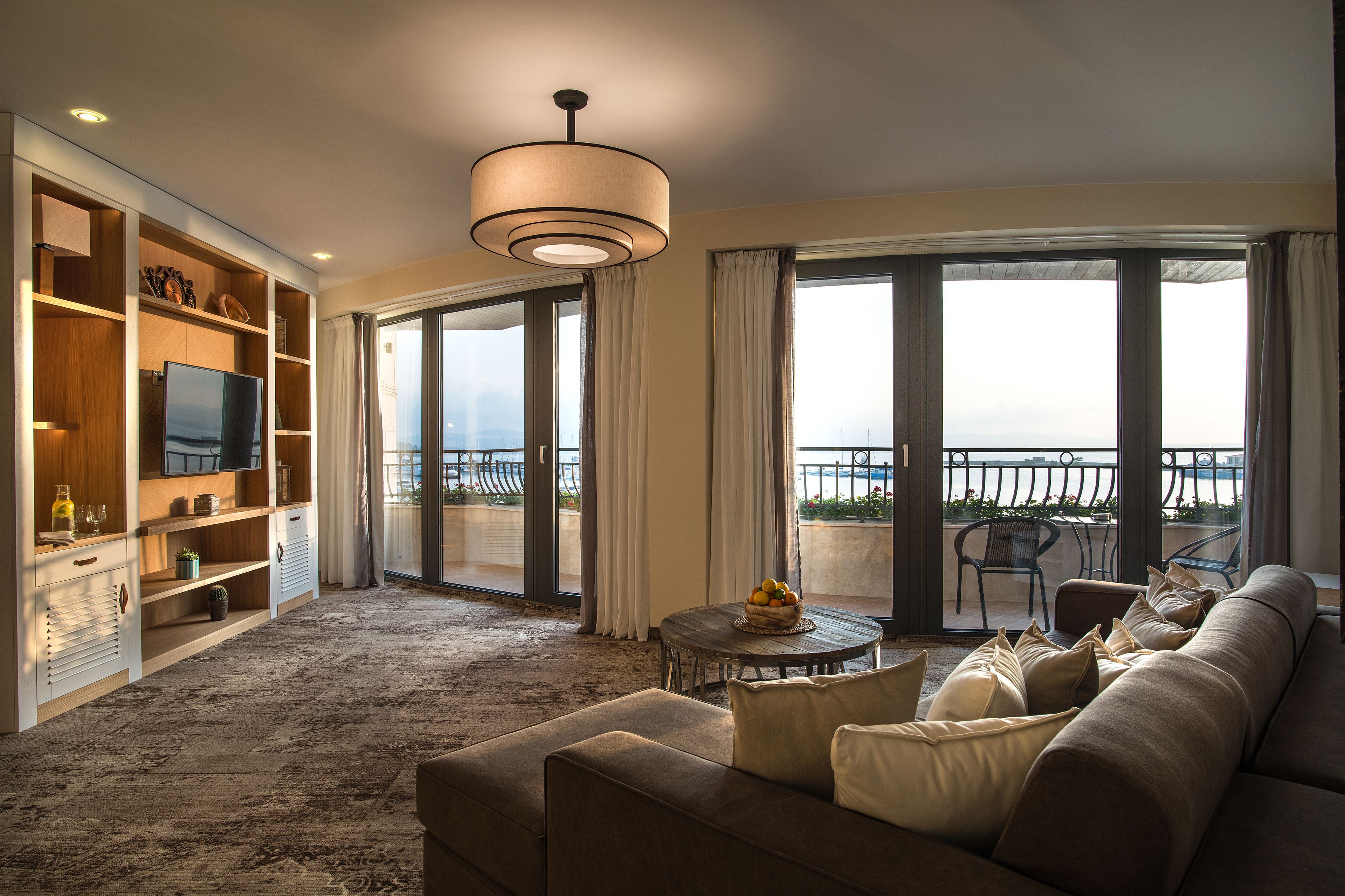 luxury apartment, 1 bedroom, sea view | living area | 49-inch flat-screen tv with cable channels, tv, books