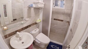 A bathroom with a sink, toilet, and shower. - Good Things (Liuqiu)