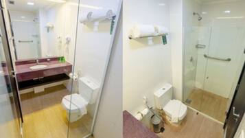 A modern bathroom with a glass shower enclosure, a marble countertop, and a white toilet.