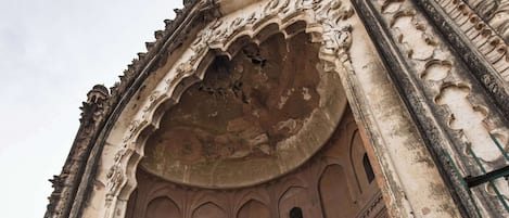 An ancient, ornate gateway with intricate carvings and a large archway.